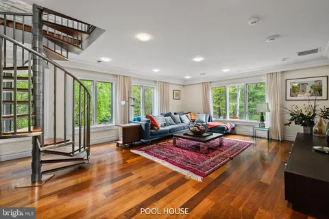 a view of a hallway with a dining table and chairs