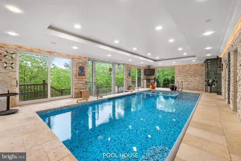 an aerial view of a house with swimming pool and garden view