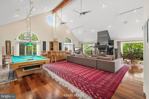 a living room with furniture a rug and a chandelier