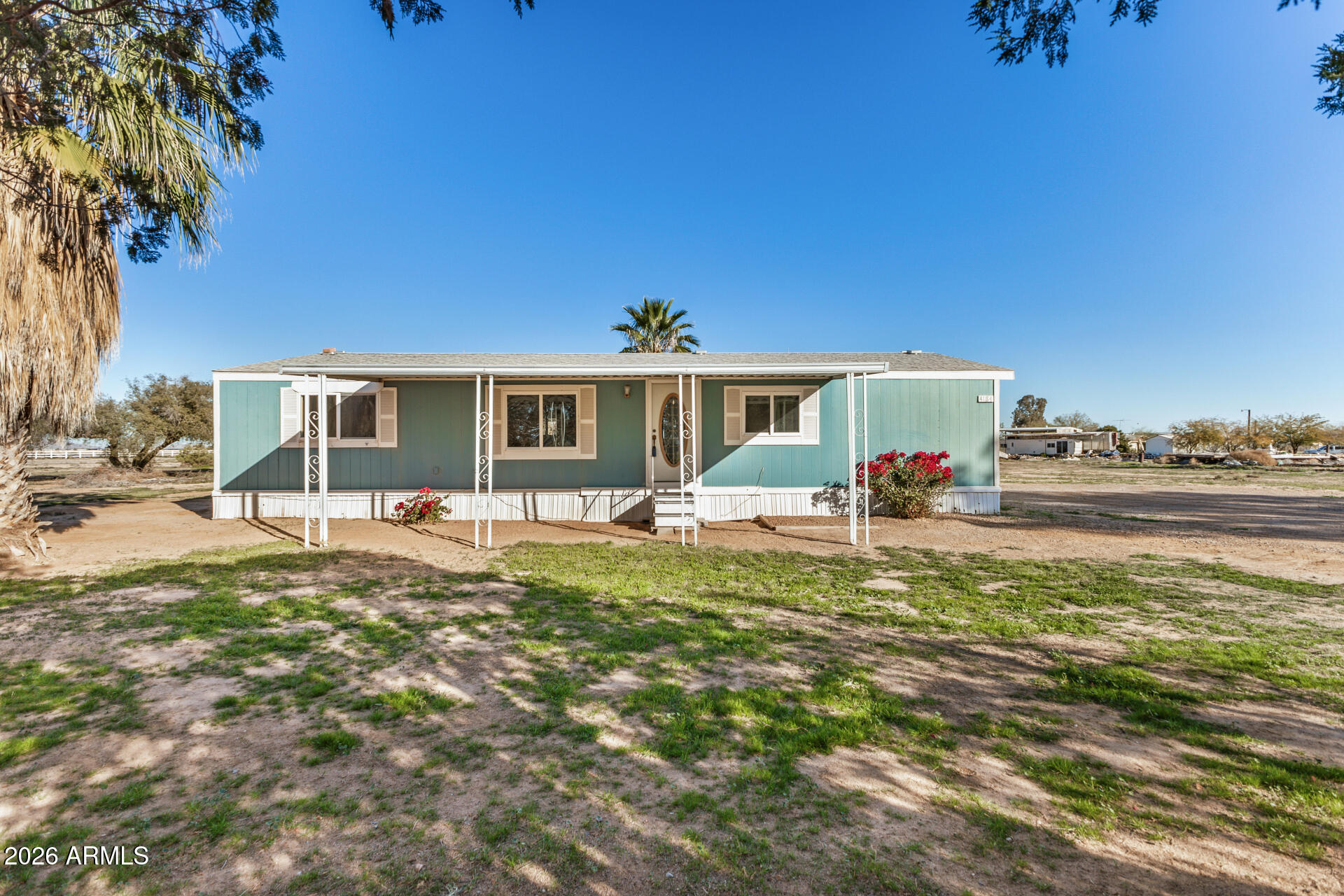 4184 Palm Lane Coolidge, AZ 85128 - Photo 1 of 47 a front view of a house with a garden