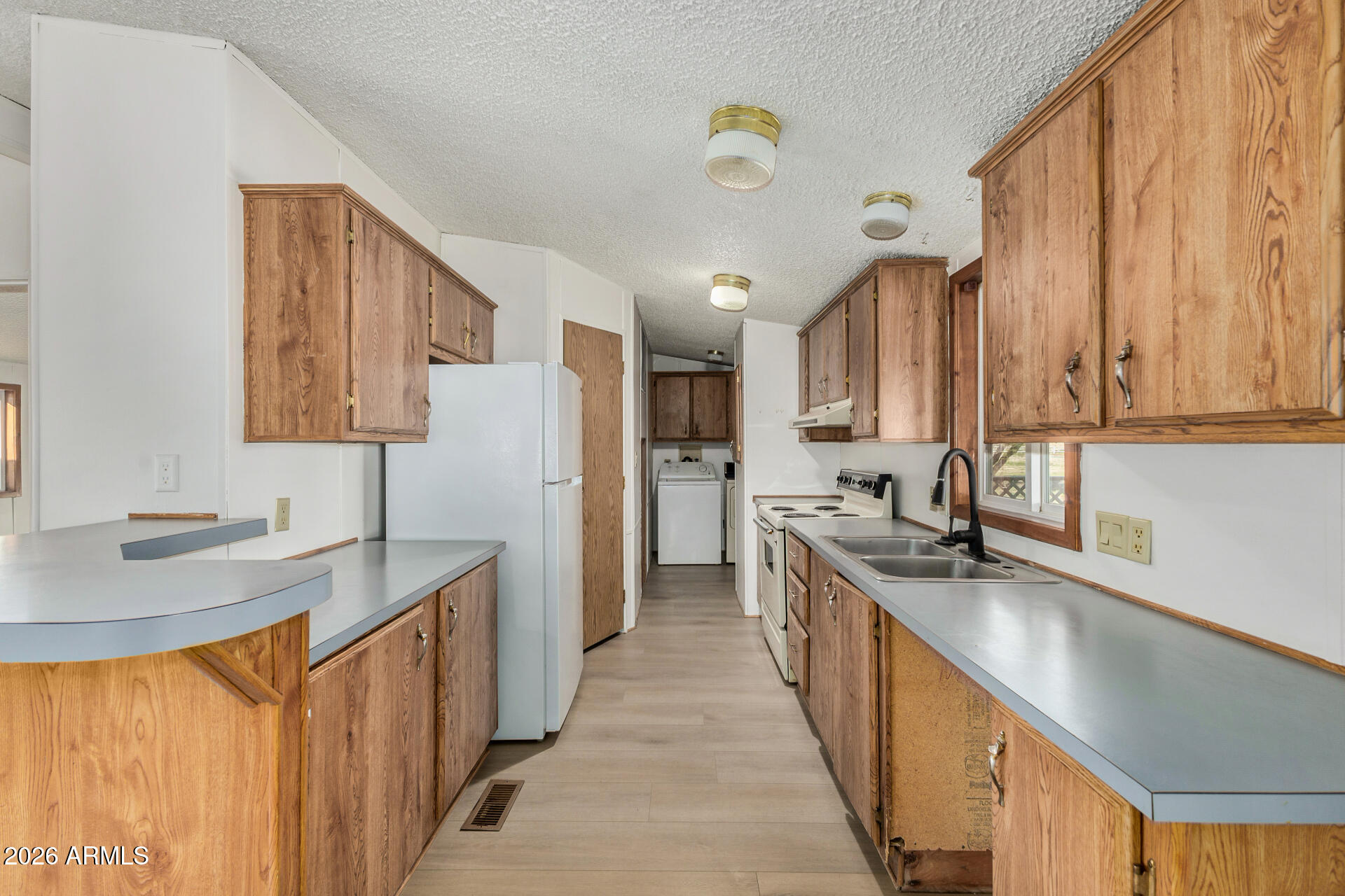 4184 Palm Lane Coolidge, AZ 85128 - Photo 11 of 47 a kitchen with stainless steel appliances granite countertop a sink stove and refrigerator