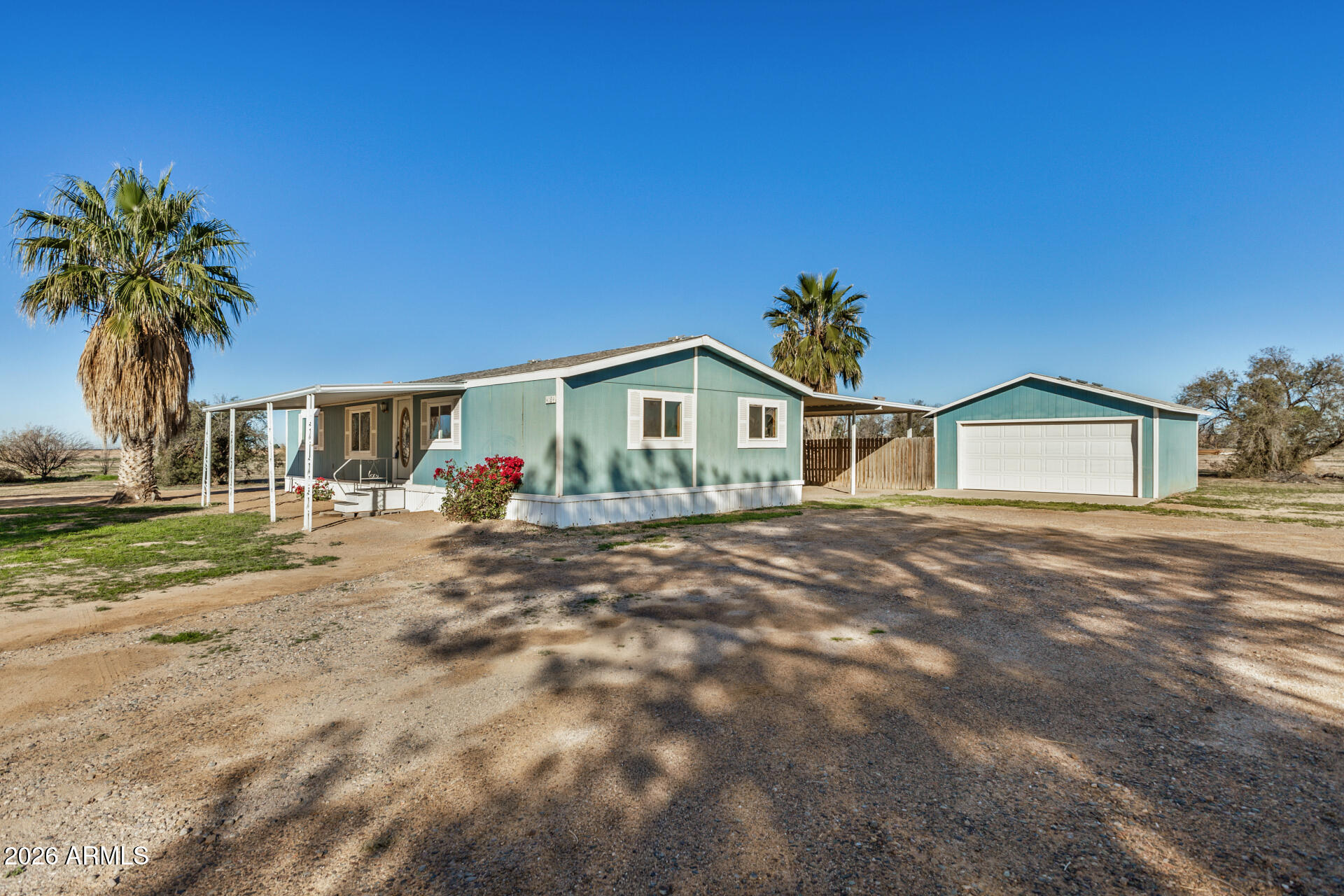 4184 Palm Lane Coolidge, AZ 85128 - Photo 3 of 47 a front view of a house with garden