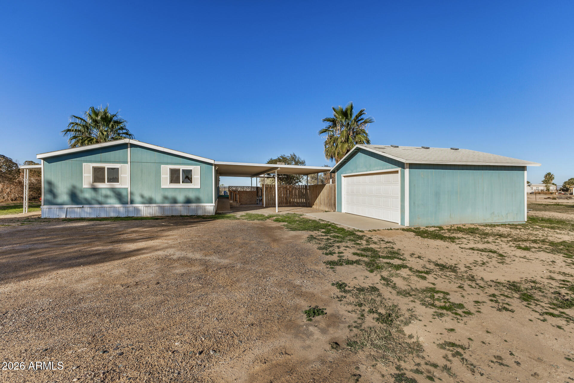4184 Palm Lane Coolidge, AZ 85128 - Photo 32 of 47 a front view of a house with a yard and garage