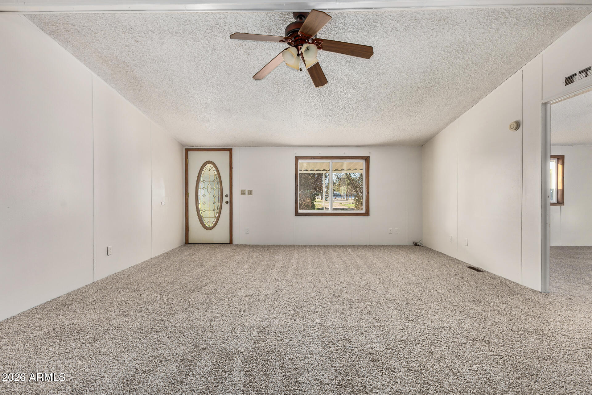 4184 Palm Lane Coolidge, AZ 85128 - Photo 7 of 47 an empty room with windows and ceiling fan