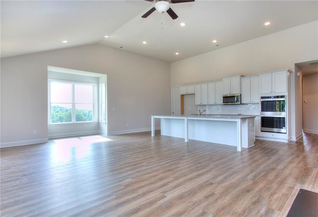 an open kitchen with kitchen island and a window