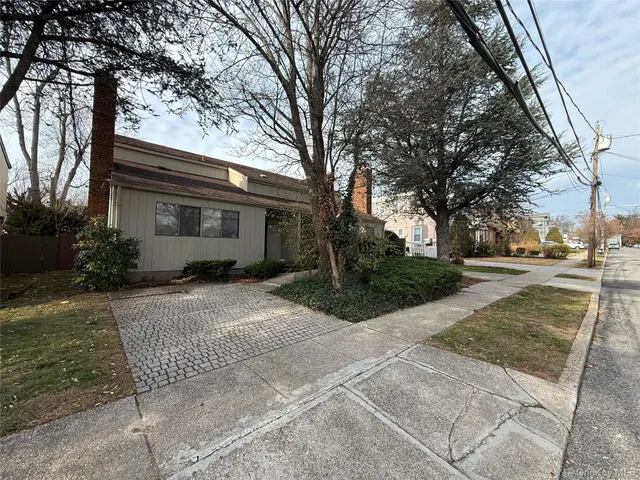 a view of empty room with wooden floor and fireplace