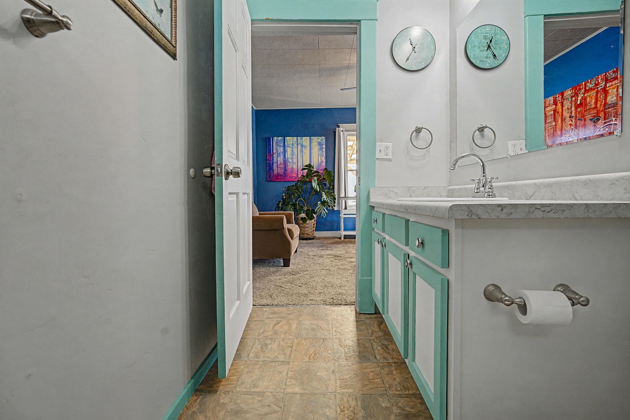 216 4th Street Clifton, CO 81520 - Photo 14 of 17 a hallway with sink and mirror