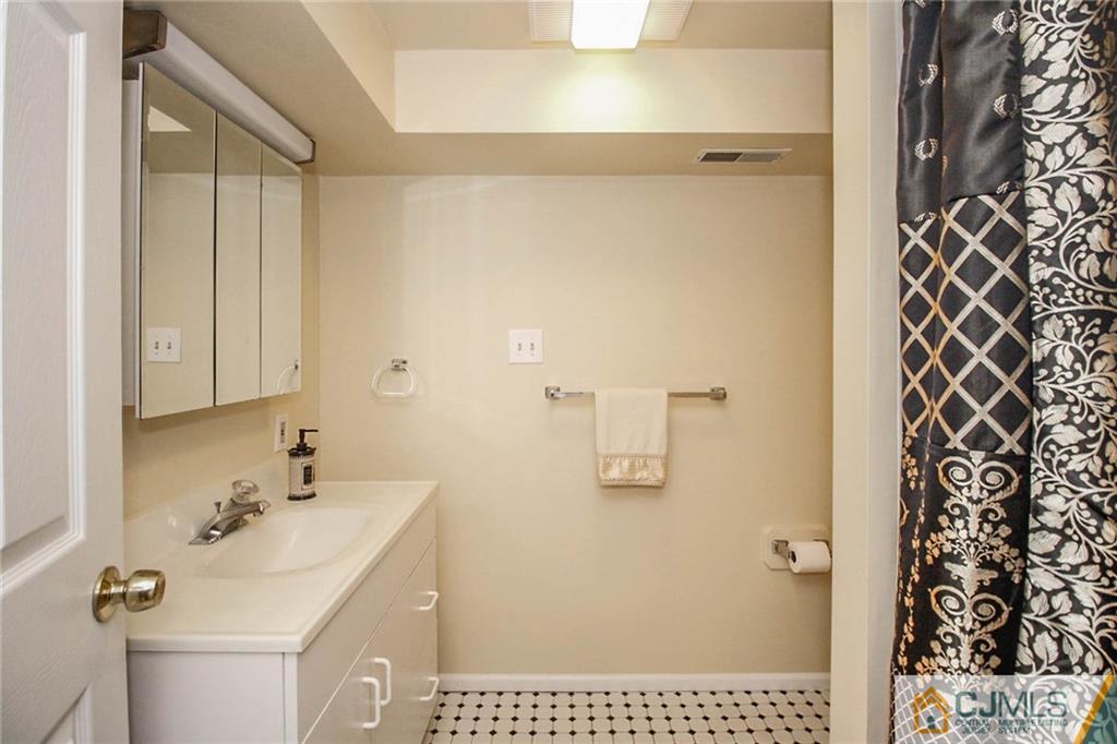 48 Harding Avenue Edison, NJ 08820 - Photo 22 of 25 a bathroom with a sink and a mirror