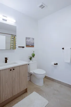 a white toilet sitting next to a bathroom sink