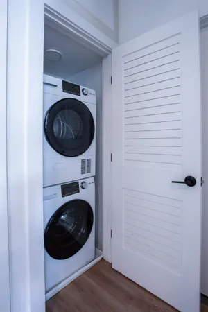 a view of a hallway with washer and dryer