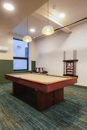 a room with pool table and a chandelier