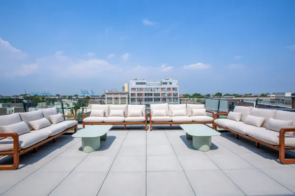 a terrace with seating space and barbeque oven