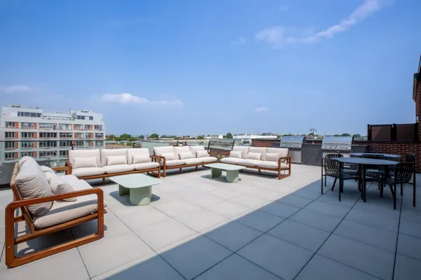 a living room with patio furniture and a potted plant