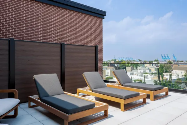 a roof deck with a table and chairs