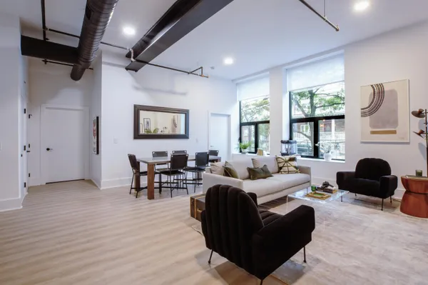 a living room with furniture window and wooden floor