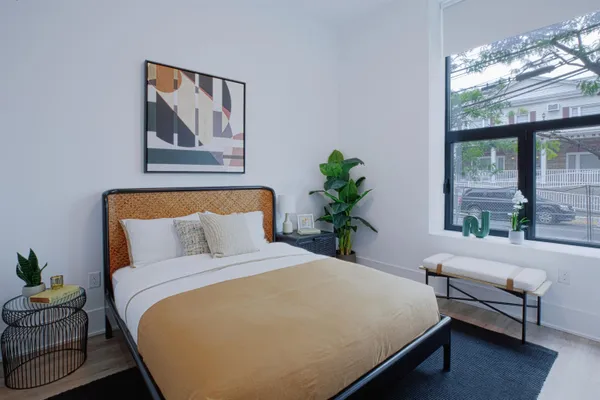 a bedroom with bed and a window