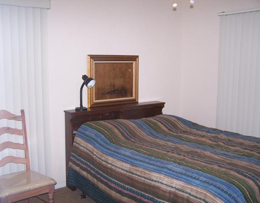 4122 Cork Drive Corpus Christi, TX 78413 - Photo 7 of 10 a bedroom with a bed and a window