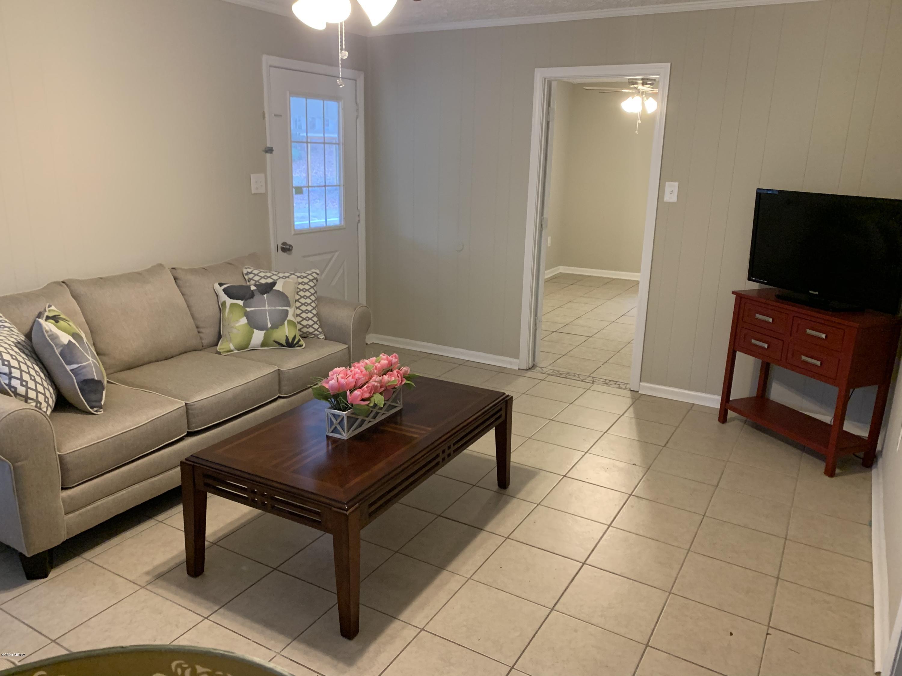 175 Red Oak Road Byron, GA 31008 - Photo 5 of 42 a living room with furniture and a flat screen tv