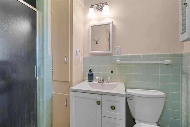 a bathroom with a sink toilet and a mirror