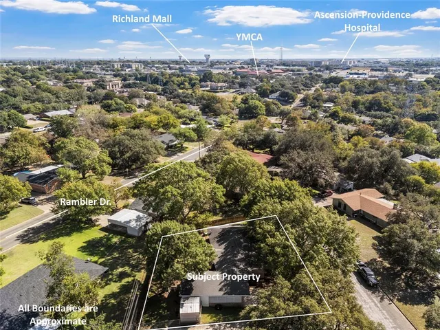 an aerial view of residential houses with city view