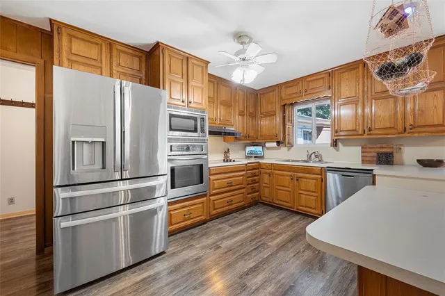 a kitchen with stainless steel appliances a refrigerator sink and cabinets