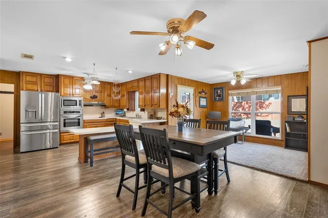 a view of a dining room with furniture and a chandelier