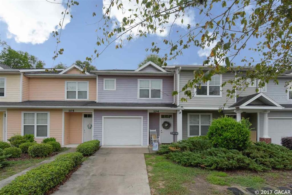 1609 Northwest 29 Road, Unit A104 Gainesville, FL 32605 - Photo 1 of 1 a front view of a house with a garden