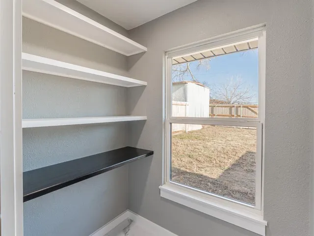 a bathroom with a double vanity sink a mirror and a bathtub
