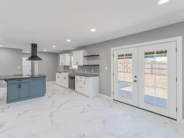 a kitchen with granite countertop a sink and a stove