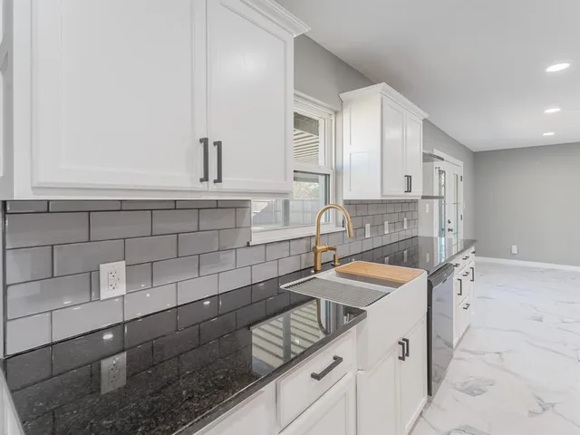 a kitchen with a table chairs and a stove