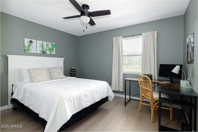 a bedroom with a bed and a desk