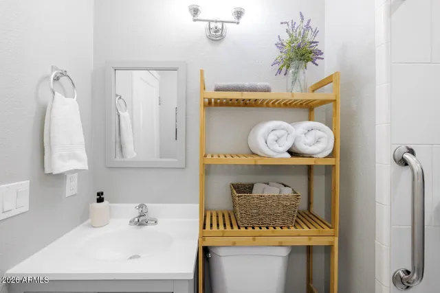 a bathroom with a sink a mirror and vanity