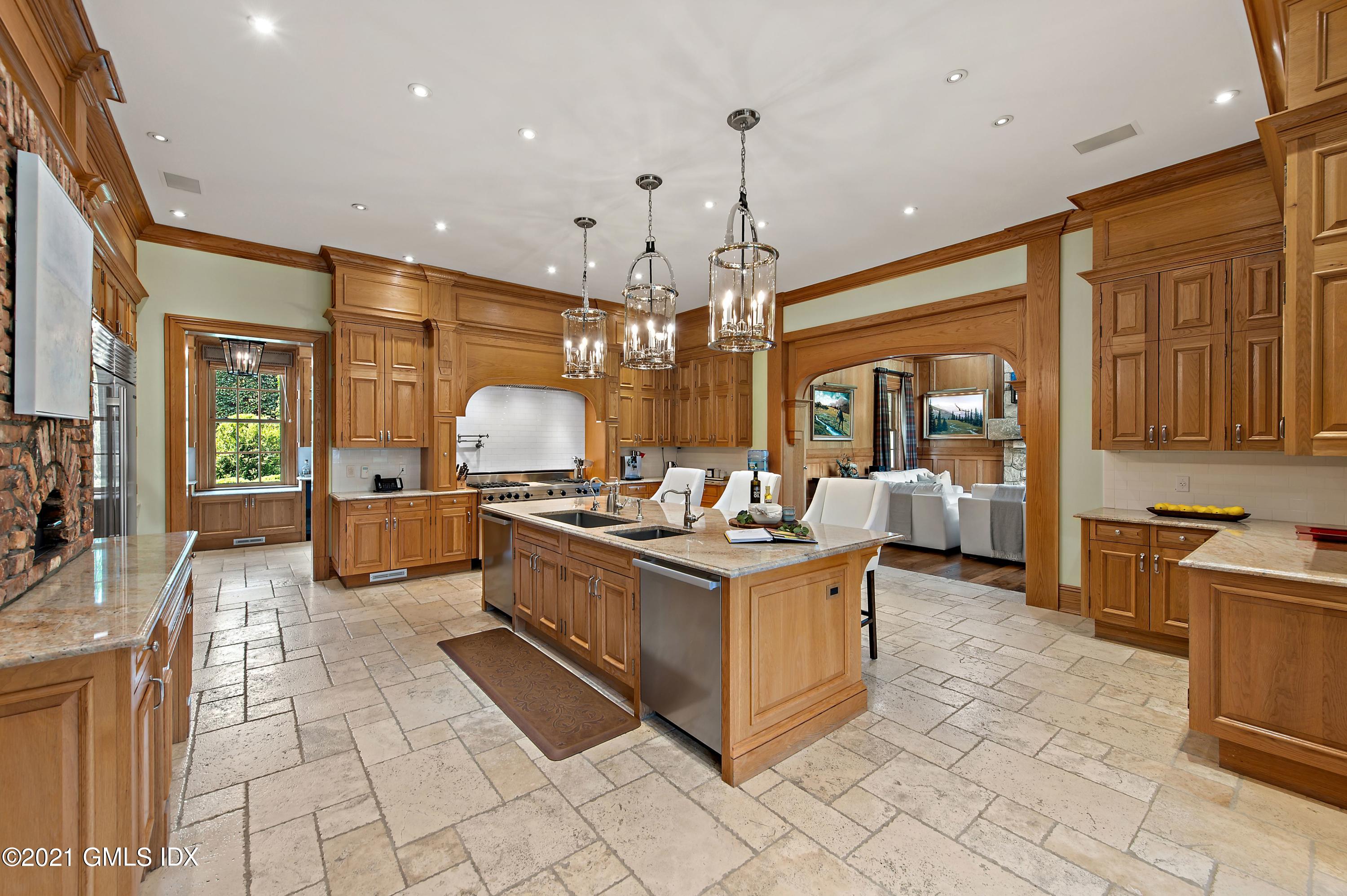 435 Round Hill Road Greenwich, CT 06831 - Photo 11 of 44 a kitchen with stainless steel appliances granite countertop a stove and a view of living room