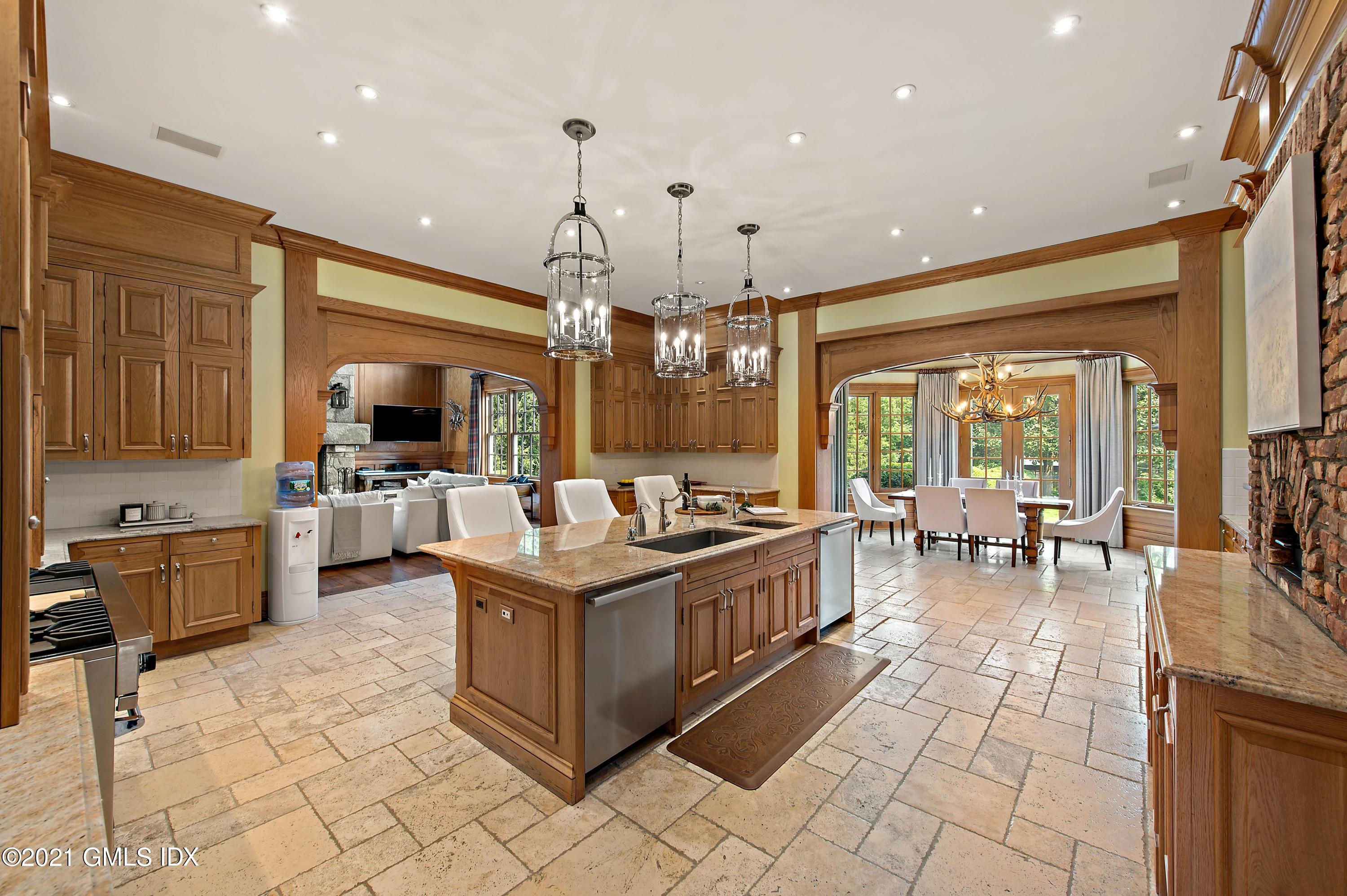 435 Round Hill Road Greenwich, CT 06831 - Photo 12 of 44 a kitchen with stainless steel appliances granite countertop a stove and a view of living room