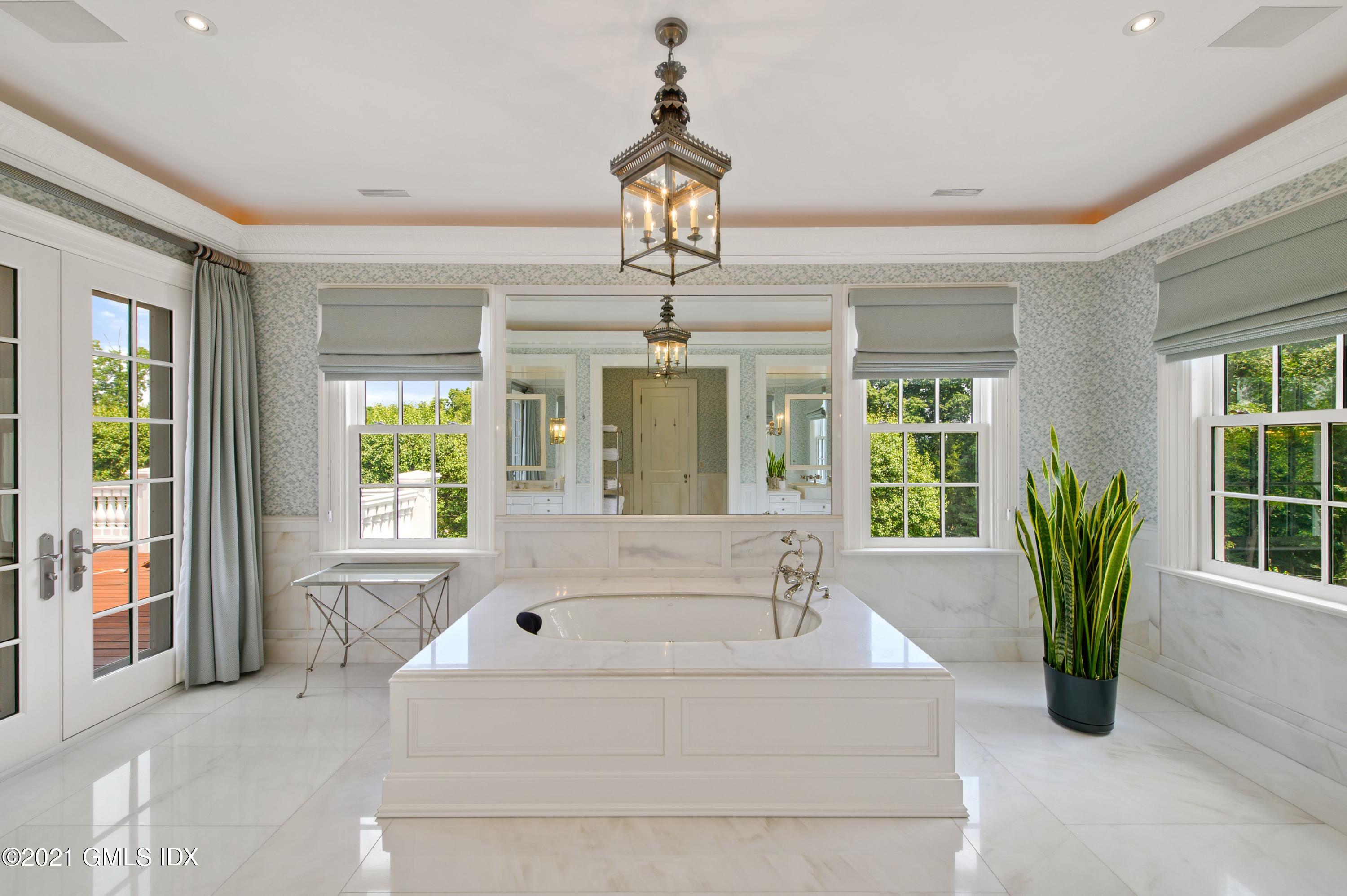 435 Round Hill Road Greenwich, CT 06831 - Photo 19 of 44 a white bath tub sitting in a living room next to a window