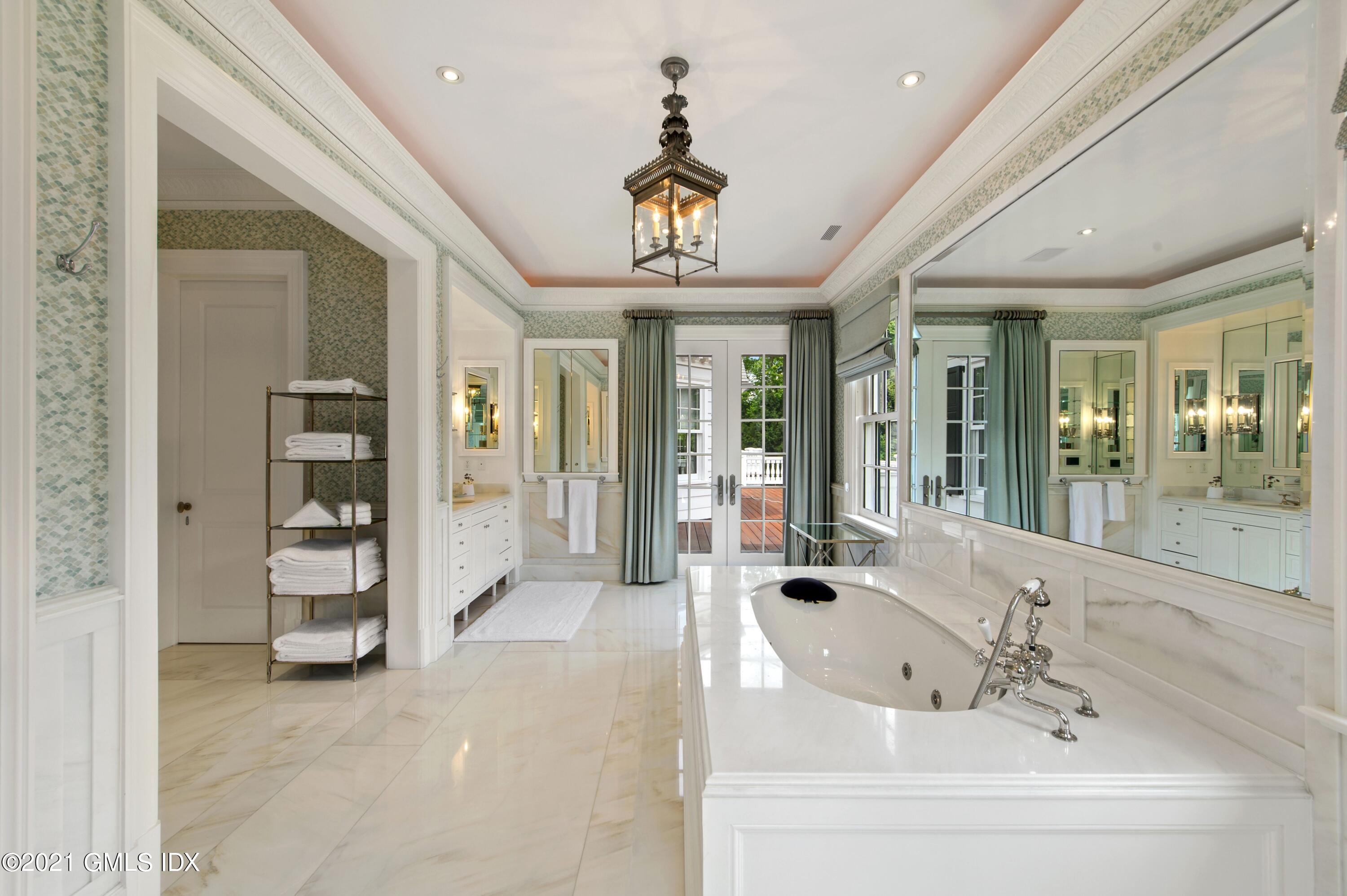 435 Round Hill Road Greenwich, CT 06831 - Photo 20 of 44 a view of spacious bathroom with a tub shower and mirror