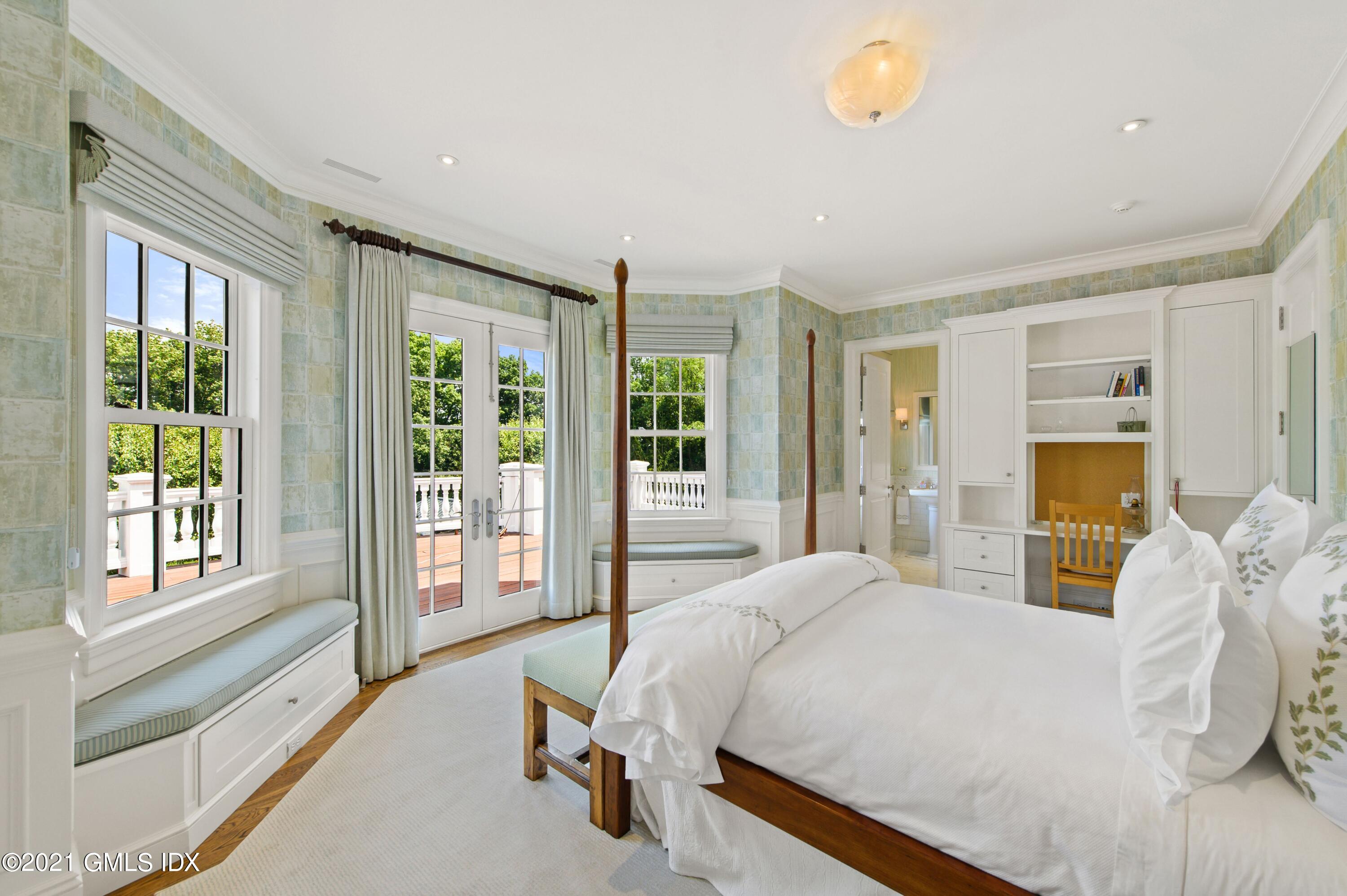 435 Round Hill Road Greenwich, CT 06831 - Photo 21 of 44 a bedroom with a large bed and a large window