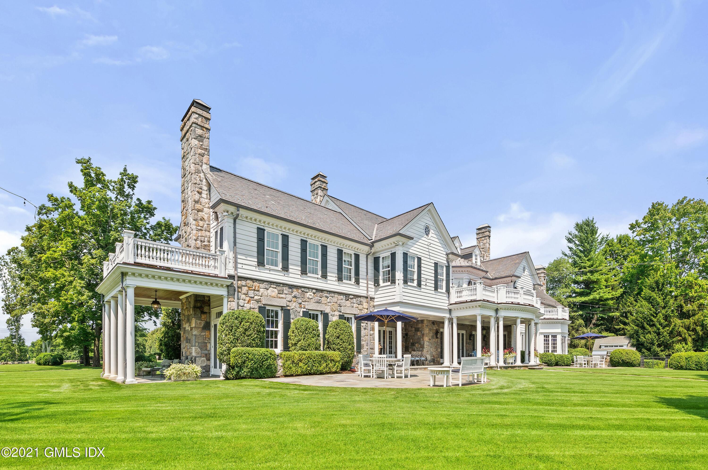 435 Round Hill Road Greenwich, CT 06831 - Photo 31 of 44 a front view of a building with a garden