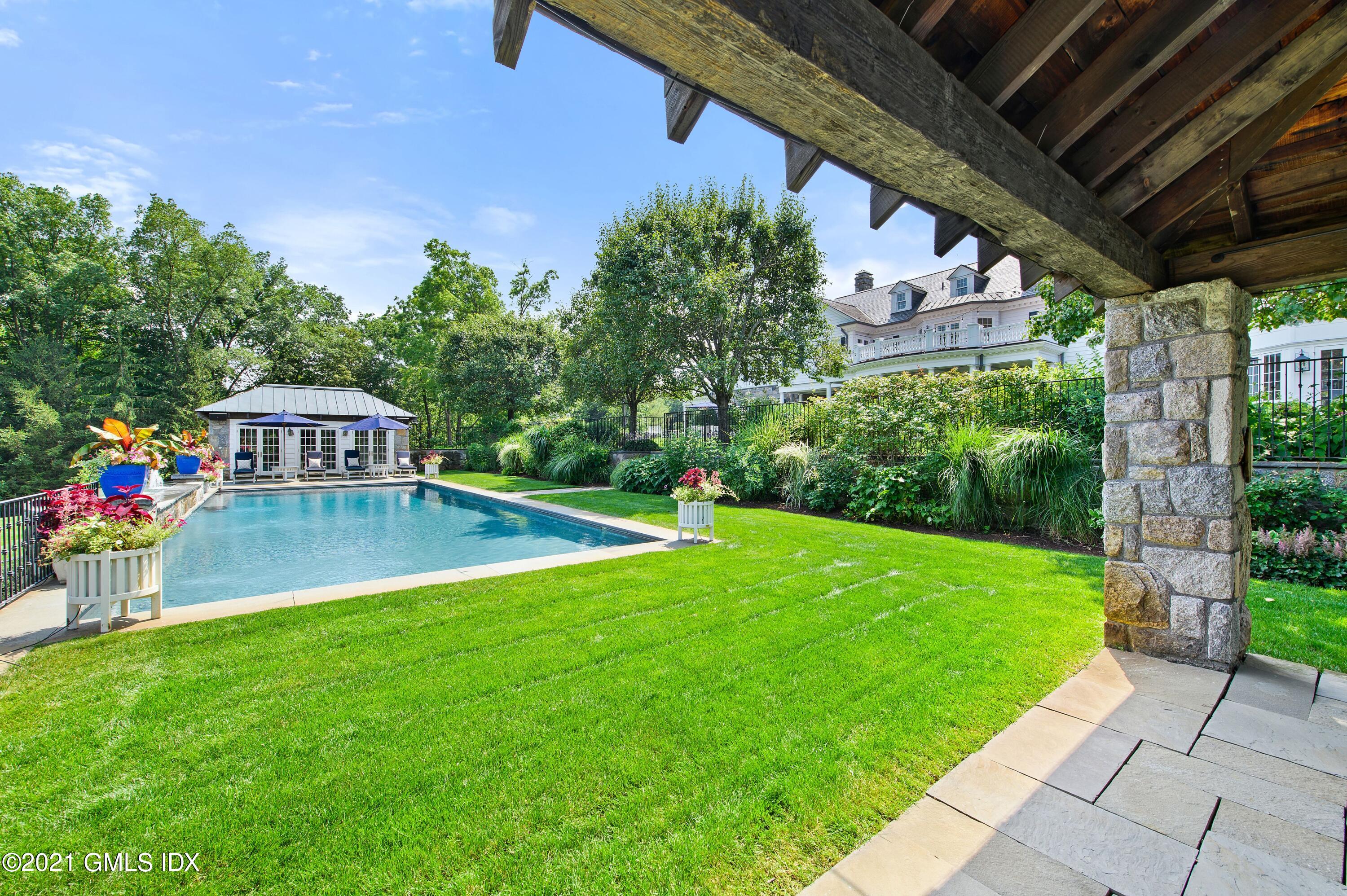 435 Round Hill Road Greenwich, CT 06831 - Photo 34 of 44 a view of a swimming pool with a patio
