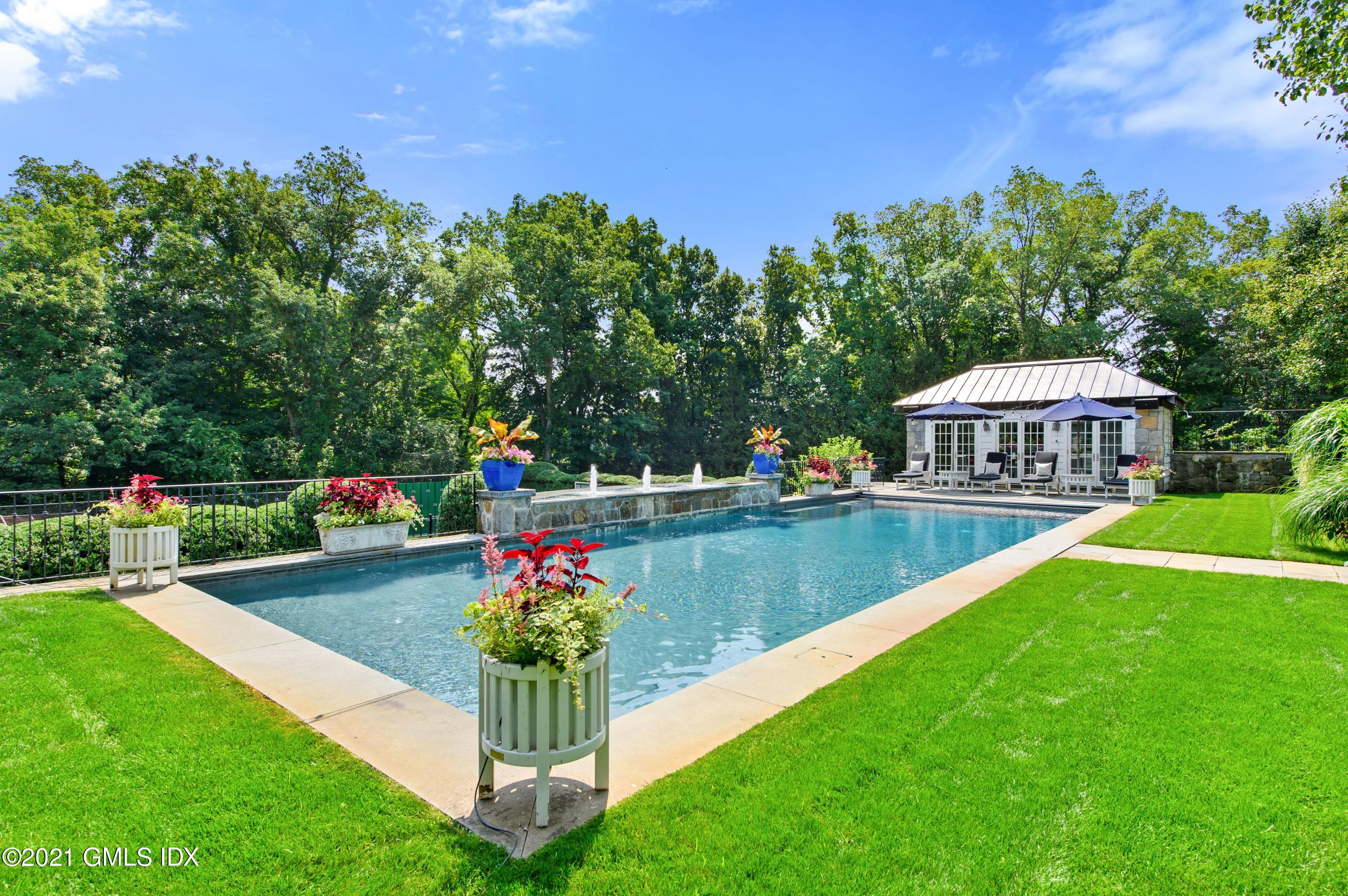 435 Round Hill Road Greenwich, CT 06831 - Photo 35 of 44 a view of a house with a yard and a garden