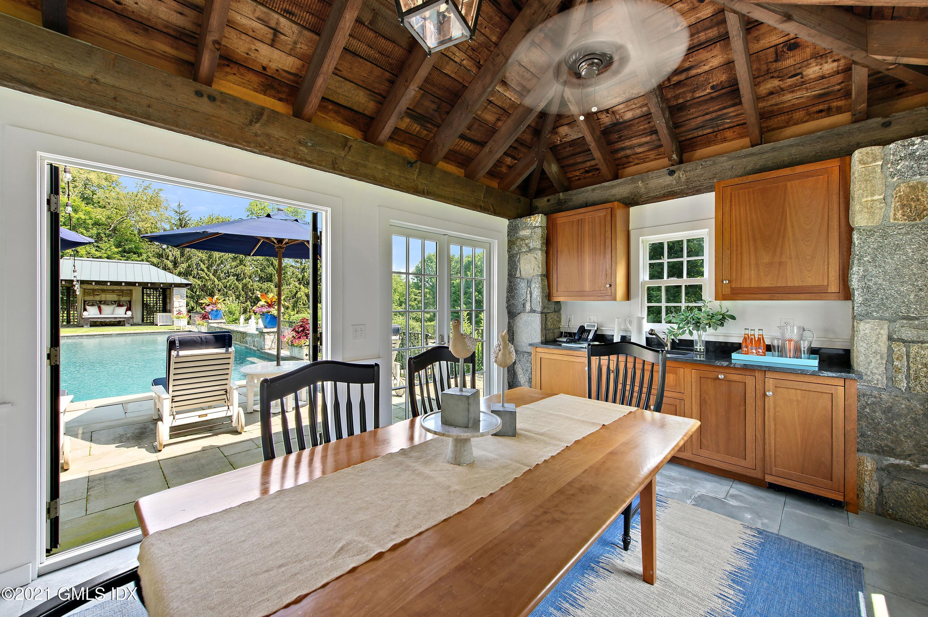 435 Round Hill Road Greenwich, CT 06831 - Photo 38 of 44 a dining room with furniture a chandelier and wooden floor