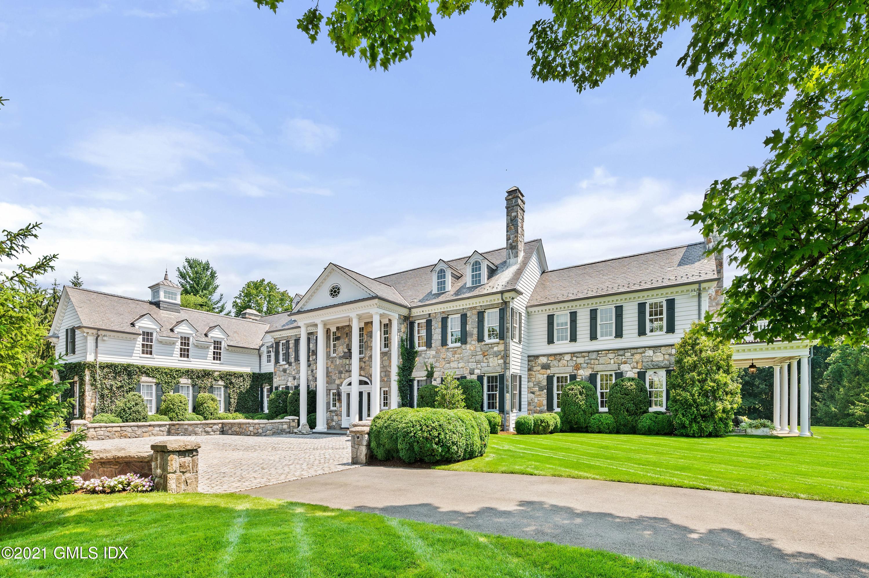 435 Round Hill Road Greenwich, CT 06831 - Photo 4 of 44 a front view of a house with a yard