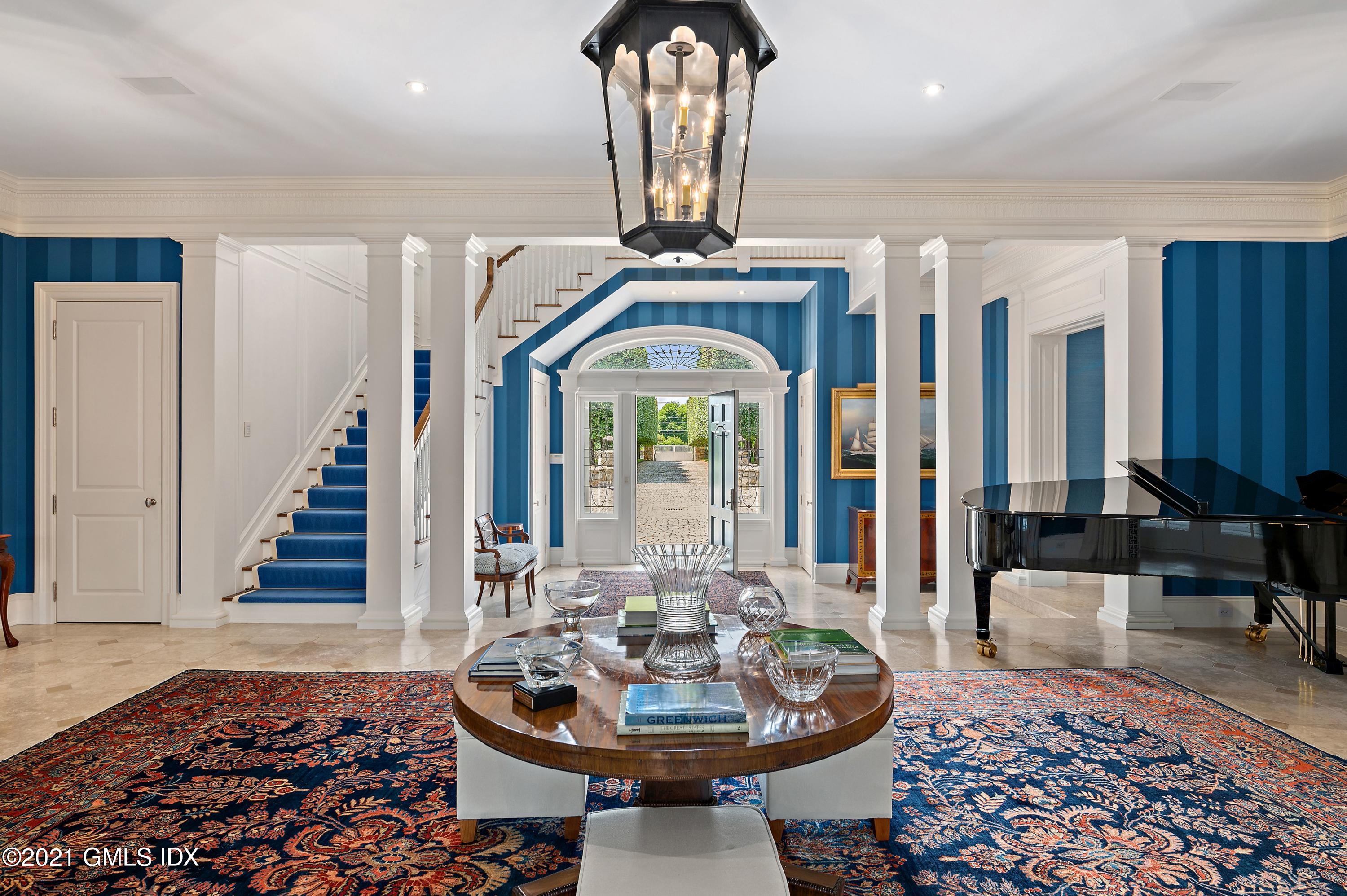435 Round Hill Road Greenwich, CT 06831 - Photo 5 of 44 a dining room with furniture wooden floor and a rug