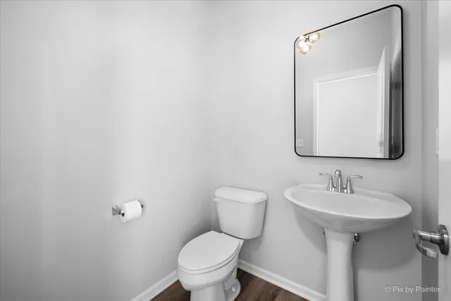 a bathroom with a sink toilet and mirror