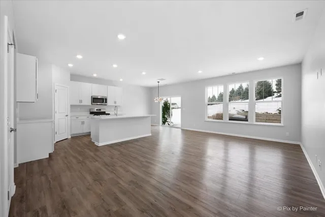 a view of kitchen with cabinets and wooden floor