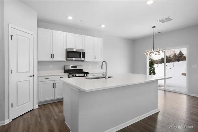 a kitchen with a sink a stove and cabinets