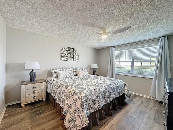 a bedroom with a bed and a large window