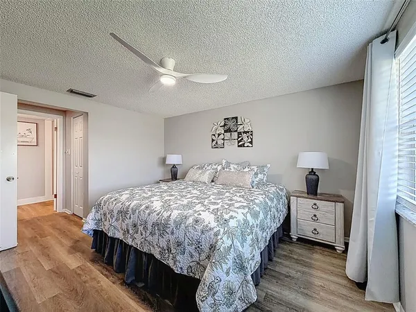 a bedroom with a bed and a night stand