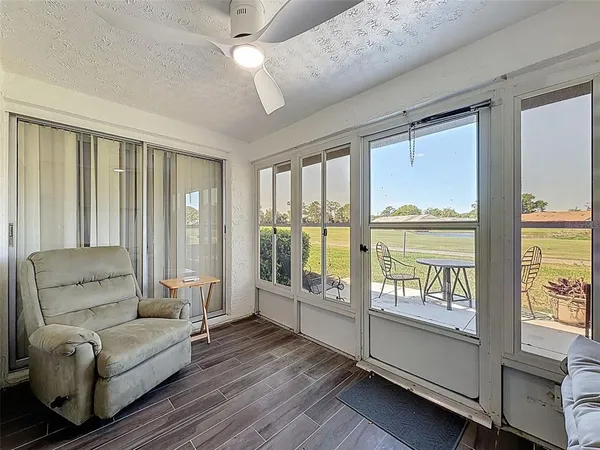 a living room with furniture and floor to ceiling windows