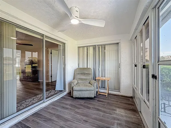 a view of a livingroom with furniture wooden floor and window